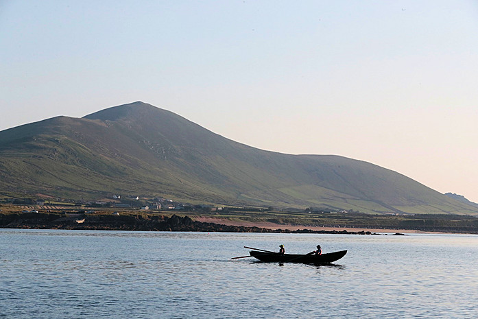 Couple in currach greet us in Irish